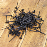 Pile of blacksmiths nails in a forge blackened finish - ABC Ironmongery